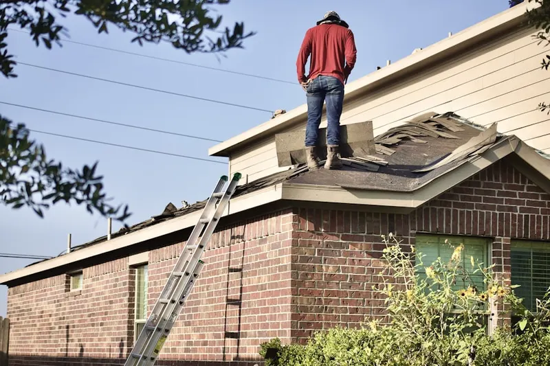 Professional roofer working on a residential roof in Emory